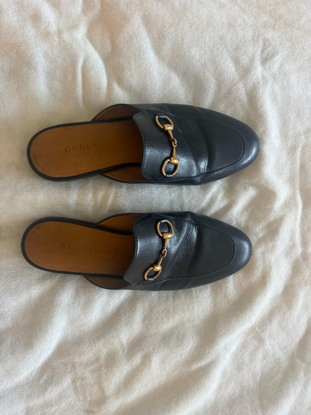 Black leather Gucci Princetown mules, featuring the iconic gold-tone Horsebit de